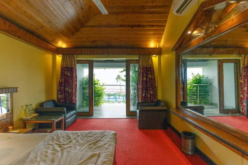 a bedroom with a bed and a living room at Hotel Seagull in Digha