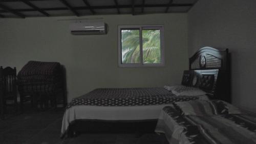 a bedroom with two beds and a window at bethi farms in Malkāpur