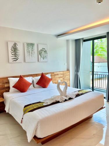 a bedroom with a large bed with a swan on it at Ozone hotel khanom in Khanom