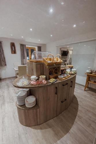 a kitchen with a counter with dishes on it at Gästehaus Achental in Berchtesgaden