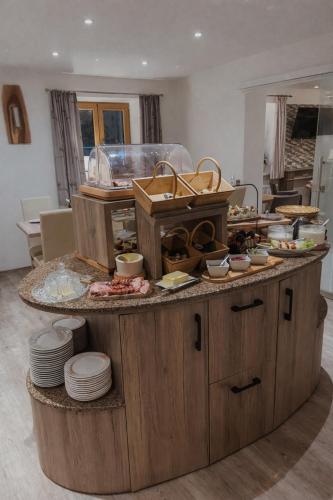 a kitchen with a counter with dishes on it at Gästehaus Achental in Berchtesgaden