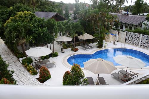 an overhead view of a pool with umbrellas and chairs at Godiva Villa Phu Quoc in Phu Quoc