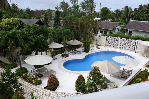 an aerial view of a resort pool with umbrellas at Godiva Villa Phu Quoc in Phu Quoc