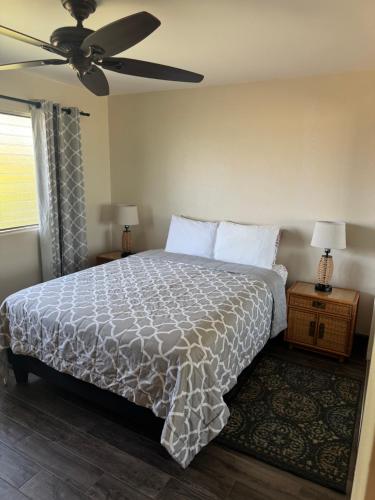 a bedroom with a bed and a ceiling fan at The Happy Hideaway - Maui Calm by the Ocean in Kihei