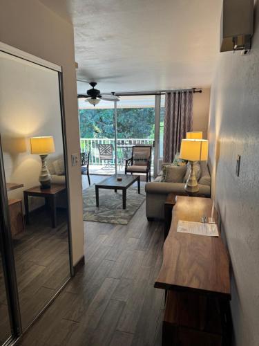 a living room with a couch and a table at The Happy Hideaway - Maui Calm by the Ocean in Kihei