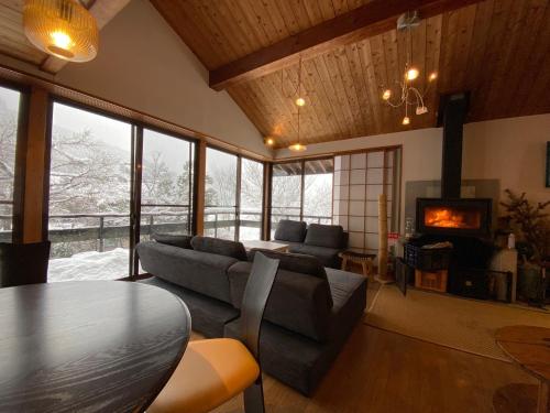 a living room with a couch and a table at kakayama hutte in Muraoka