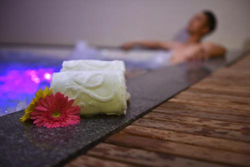 a towel and a flower on a table in a pool at Khanh Linh Hotel in Pleiku