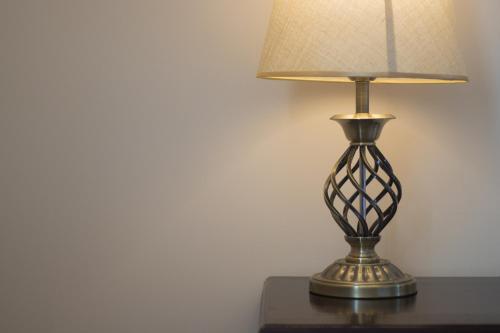 a metal lamp sitting on a table with a lamp shade at Khanh Linh Hotel in Pleiku