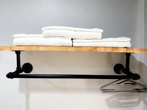 a stack of towels on a wooden shelf at 9TY hotel (ninety hotel) in Bangkok