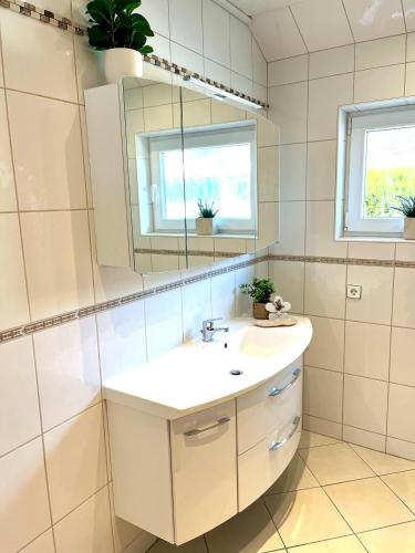 a bathroom with a sink and a mirror at Ferienwohnung Joanna in Norddeich