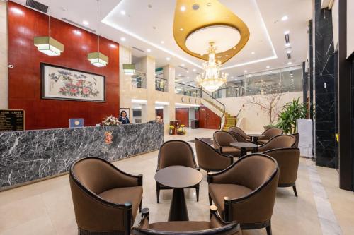 a lobby with a row of chairs and a bar at Red River View Hotel in Lao Cai