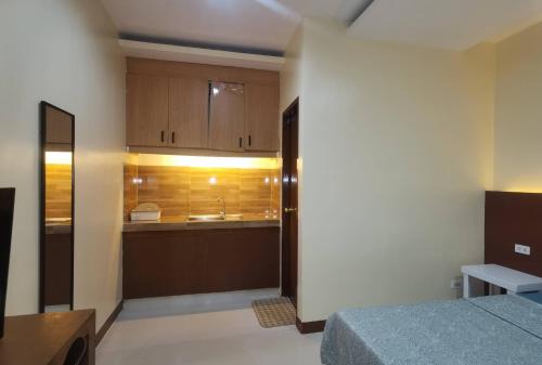 a small room with a bed and a kitchen at Little Haven at Lio in El Nido