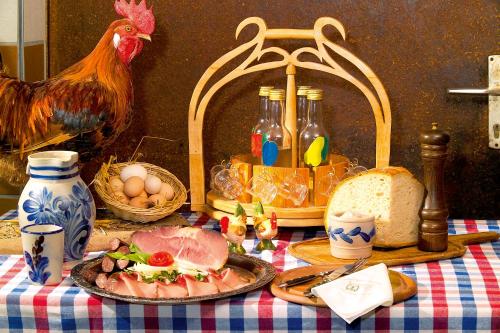 a table with a plate of food and a chicken and eggs at Gasthaus-Pension Zum Kreuz in Stühlingen