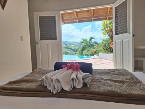 a bedroom with a bed with a view of a pool at villa vue mer - piscine privée in Las Terrenas
