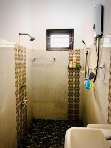 a bathroom with a shower and a sink at Shanu home stay in Beliatta