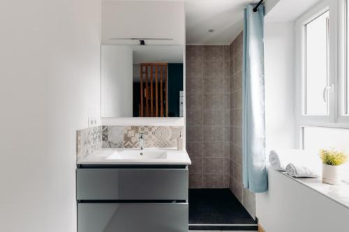 a white bathroom with a sink and a window at La Villa d'Hélène Chambre d'hôtes BnB - Cluses - Parking Voiture - Moto - Vélo in Cluses