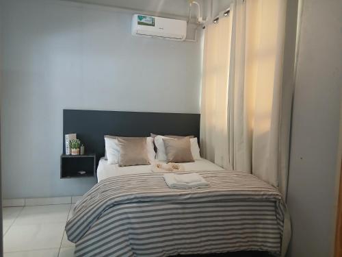 a bed with a teddy bear sitting on top of it at The Views Apartments in Kariba