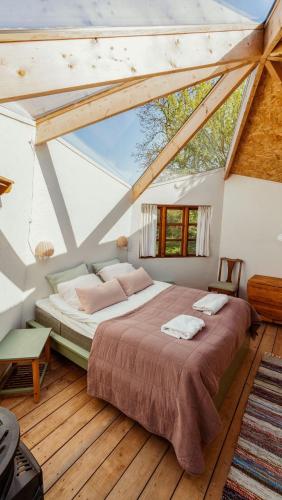 a bedroom with a large bed in a attic at Camønogaarden B&B, darksky cabins and events in Borre