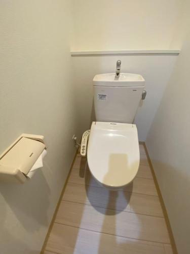 a bathroom with a white toilet in a room at 大阪難波ELLY-ten in Osaka
