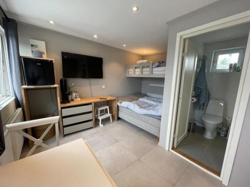 a small room with a bedroom with a bed and a desk at Siam Homestay 2 in Mölndal