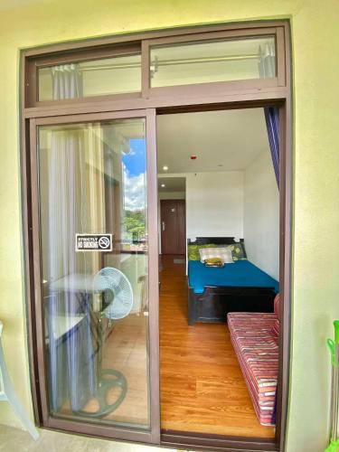 a room with a sliding glass door with a bedroom at 8F-08 Overlooking Condo at Megatower 3 in Baguio
