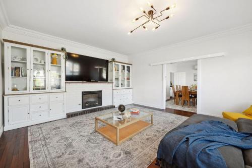 a living room with a couch and a fireplace at Bedford Pool Oasis - Comfort near CBD & Airport in Perth