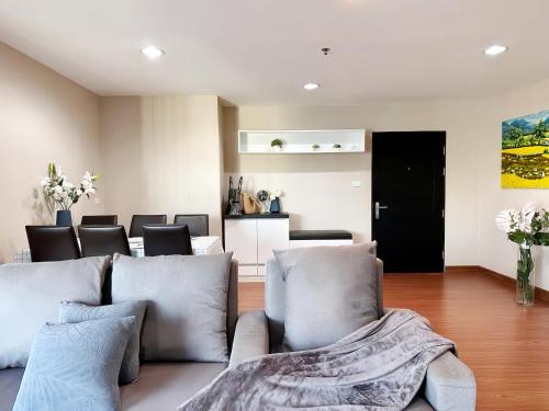 a living room with a couch and chairs at Belle Grand Rama 9 Bangkok in Bangkok