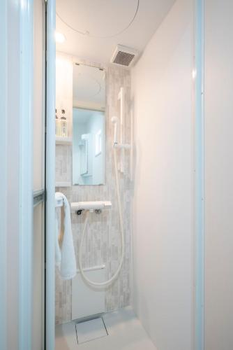 a bathroom with a shower with a glass door at 雪舞-YukiMai in Kutchan