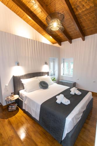 a bedroom with a large bed with towels on it at Akrolithia Guest House in Valanidorachi