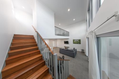 a staircase in a house with a living room at Private Mezzanine Bedroom, Soaring Ceilings, Sleeps 3, Walk to Cafes, 15 min to Bunbury in Australind