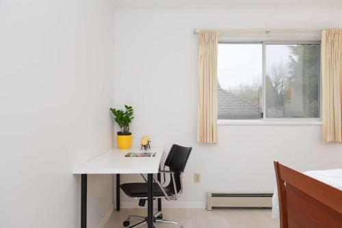 a white room with a desk and a window at Private Room with Full Amenities in Cozy House in Vancouver