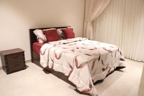a bedroom with a large bed with red pillows at Istrahtmas1 in Barka