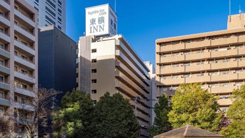 a tall building with a sign on top of it at Toyoko Inn Sendai Higashi-guchi No.1 in Sendai