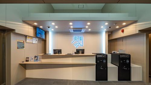 a lobby with two refrigerators and a counter in a building at Toyoko Inn Sendai Higashi-guchi No.1 in Sendai