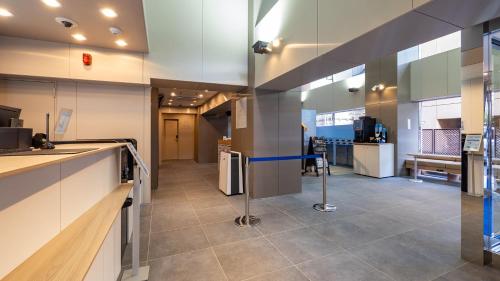 a lobby of a building with a counter and a kitchen at Toyoko Inn Sendai Higashi-guchi No.1 in Sendai