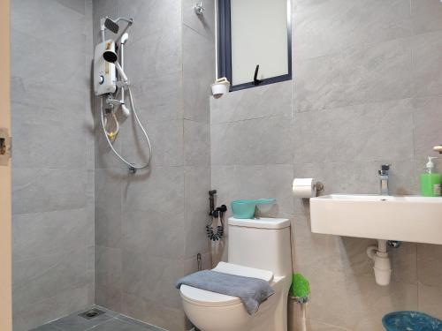 a bathroom with a toilet and a sink at Sunsuria Forum Soho by Diamond in Shah Alam