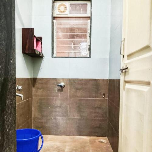 a bathroom with a shower with a window at Dapolihideaway in Dapoli