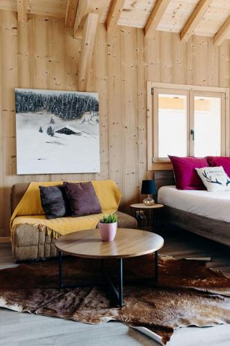 a living room with a couch and a table at La Villa d'Hélène Chambre d'hôtes BnB - Cluses - Parking Voiture - Moto - Vélo in Cluses