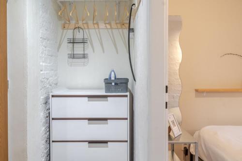 a bedroom with a bed and a white dresser at Sosnowiec Downtown Studio by BookingHost in Sosnowiec
