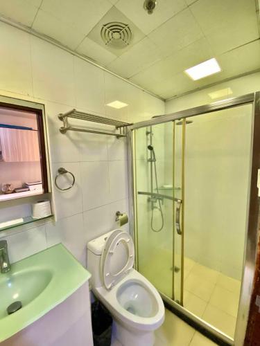 a bathroom with a shower and a toilet and a sink at 2B-15 Condo Staycation at Megatower 1 in Baguio