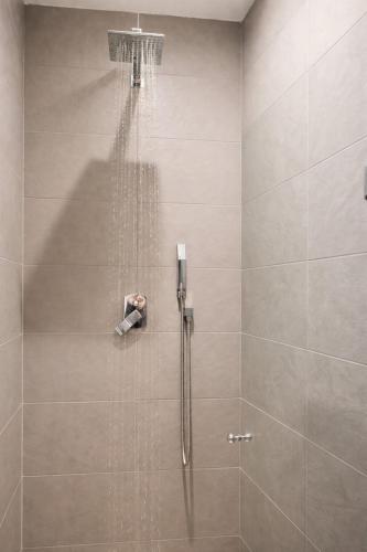 a shower with a shower head and a shower at Valletta Maisonette Malta in Valletta