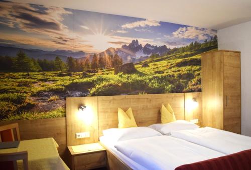 a bedroom with a large painting on the wall at Pension Vocario in Pfarrwerfen