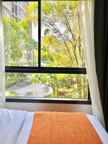 a bedroom window with a view of a tree at Dcondo Reef Serenity Condo 2 in Phuket
