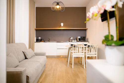 ein Wohnzimmer mit Sofa und eine Küche in der Unterkunft L'Airone Resort - Soggiorno rilassante in Irpinia in Venticano