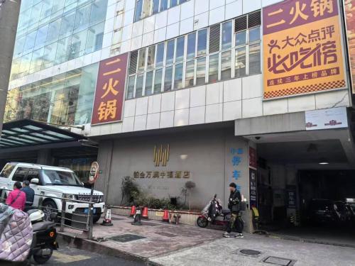 a large building with people standing outside of it at Maizi Apartment Homestay, Shanghai in Shanghai