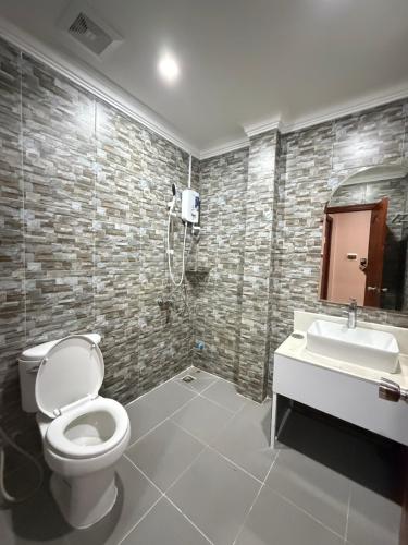 a bathroom with a toilet and a sink at The Ray Hotel & Apartments in Phnom Penh