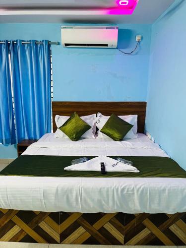 a bedroom with a bed with a towel on it at Hotel ANR Grand in Visakhapatnam