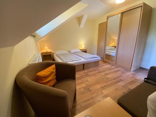 a living room with a couch and a bed at Penzión na Ráztočnom in Klenovec