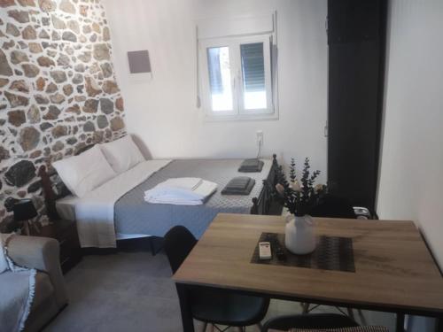 a small room with a bed and a table at Markos House 2 in Kalymnos