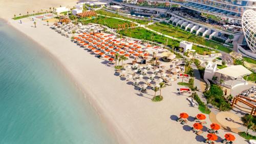 an overhead view of a beach with umbrellas and the ocean at SO Ras Al Khaimah Hotel & Resort-Ultra All Inclusive in Ras al Khaimah